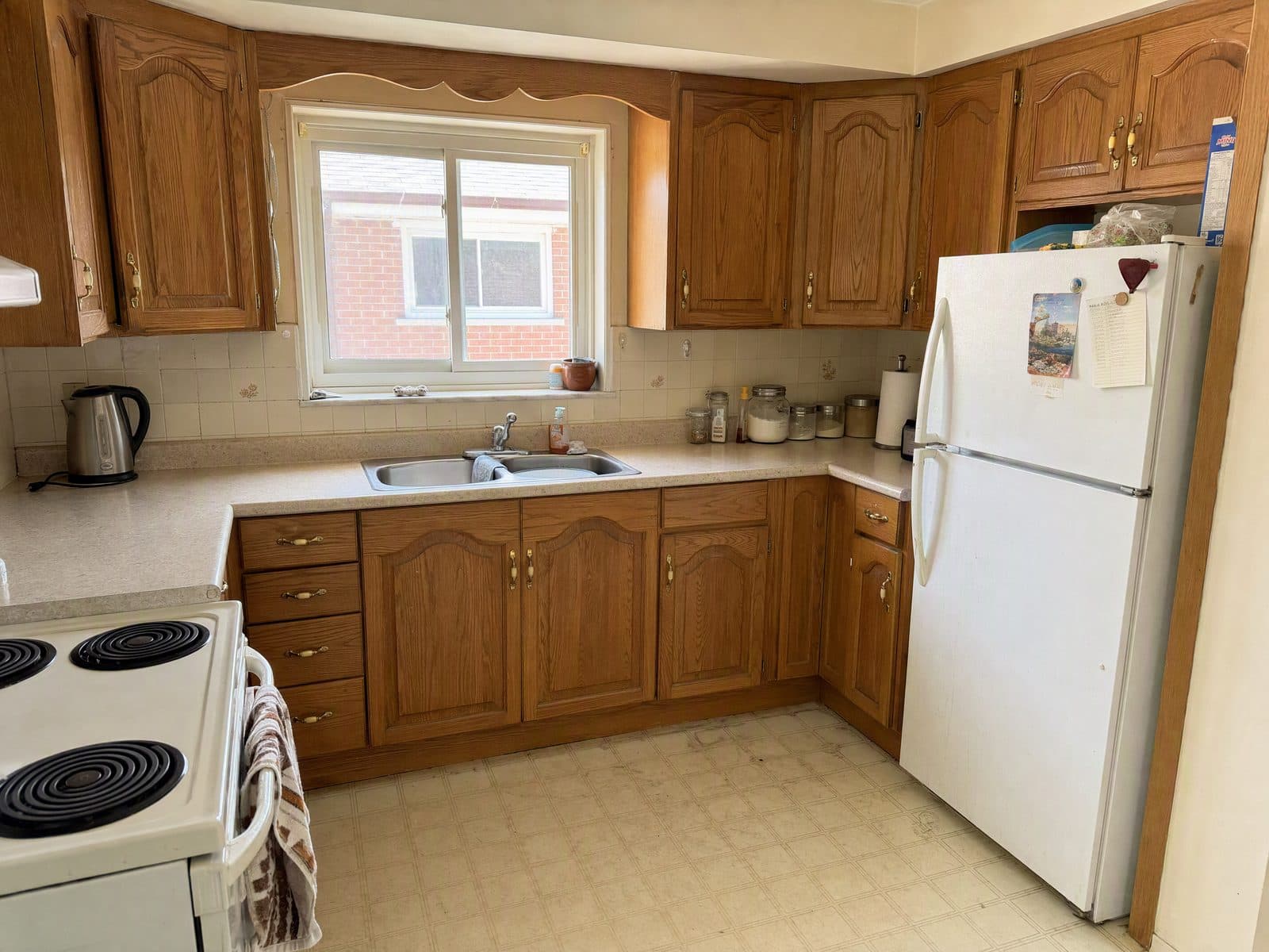 Before — a dated 1990s oak kitchen